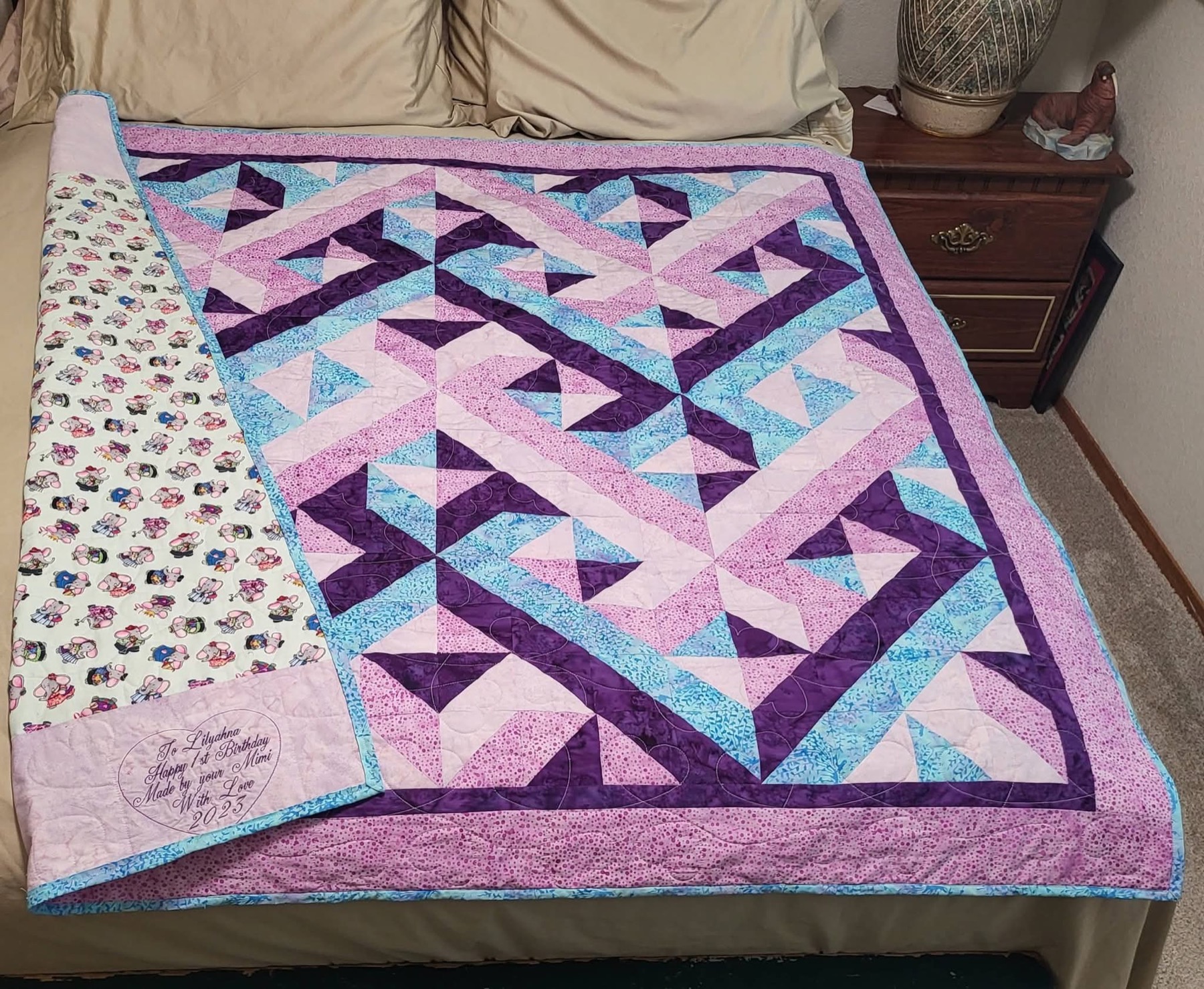 Purple and teal geometric quilt made by Tanya